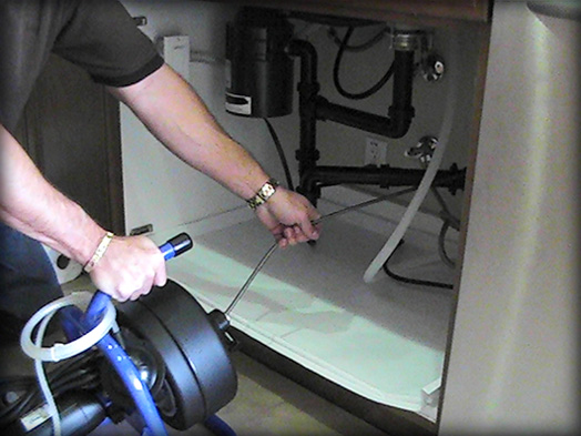 Disposable pan protects against water damage during plumbing-related work